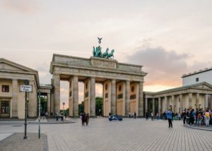A group of people standing in front of Brandenburg Gate in Germany.