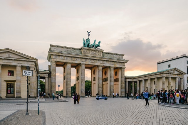 A group of people standing in front of Brandenburg Gate in Germany.